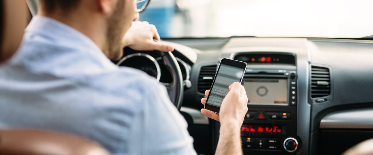 Man texting in car