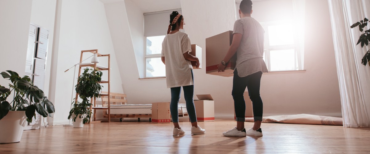Couple holding boxes moving