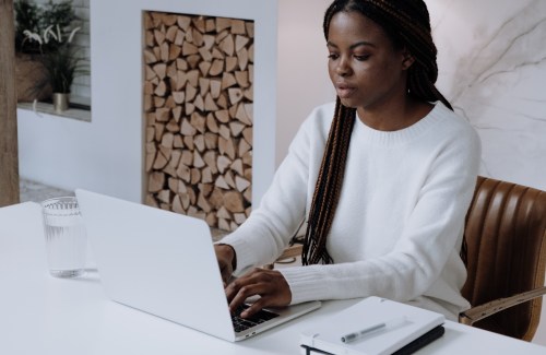 Woman writing on a laptop