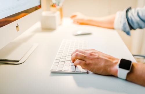 Person typing on computer