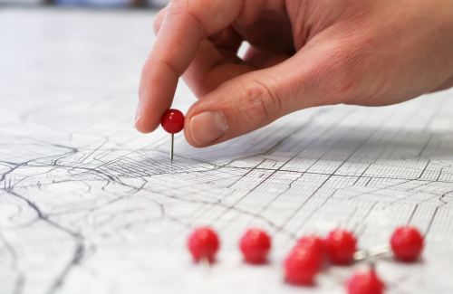 Red pins on a white map