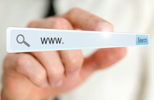 Hand holding up a URL