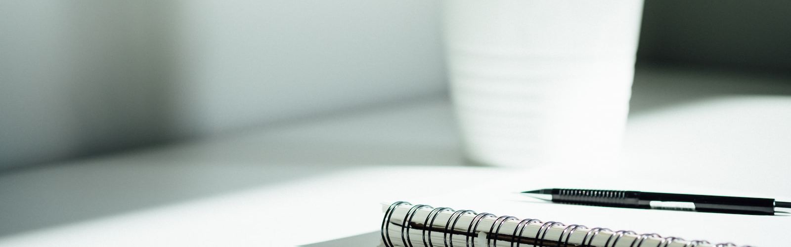 pen, notebook, and smartphone on table