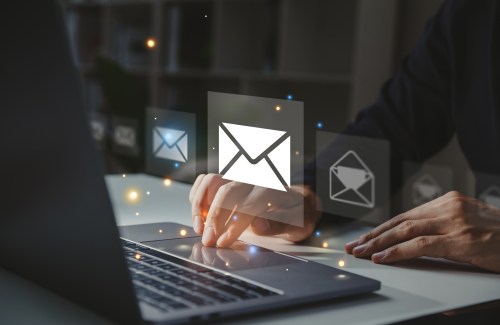 Businessman using laptop with email icon, Online communication concept.